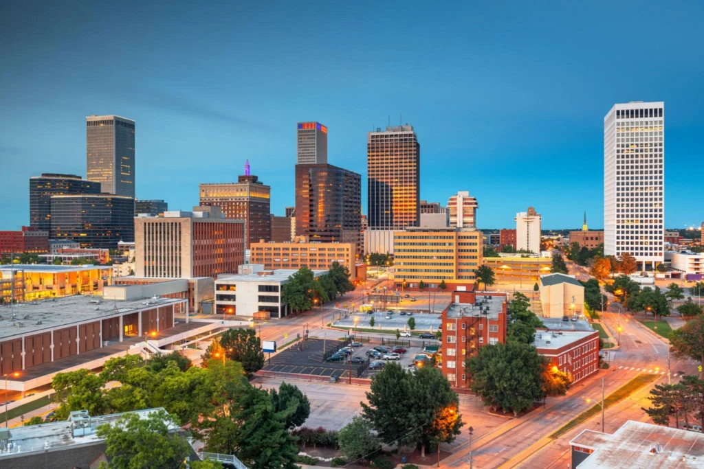 A city skyline featuring various buildings and trees, representing urban life in Oklahoma, home to immigration lawyers.