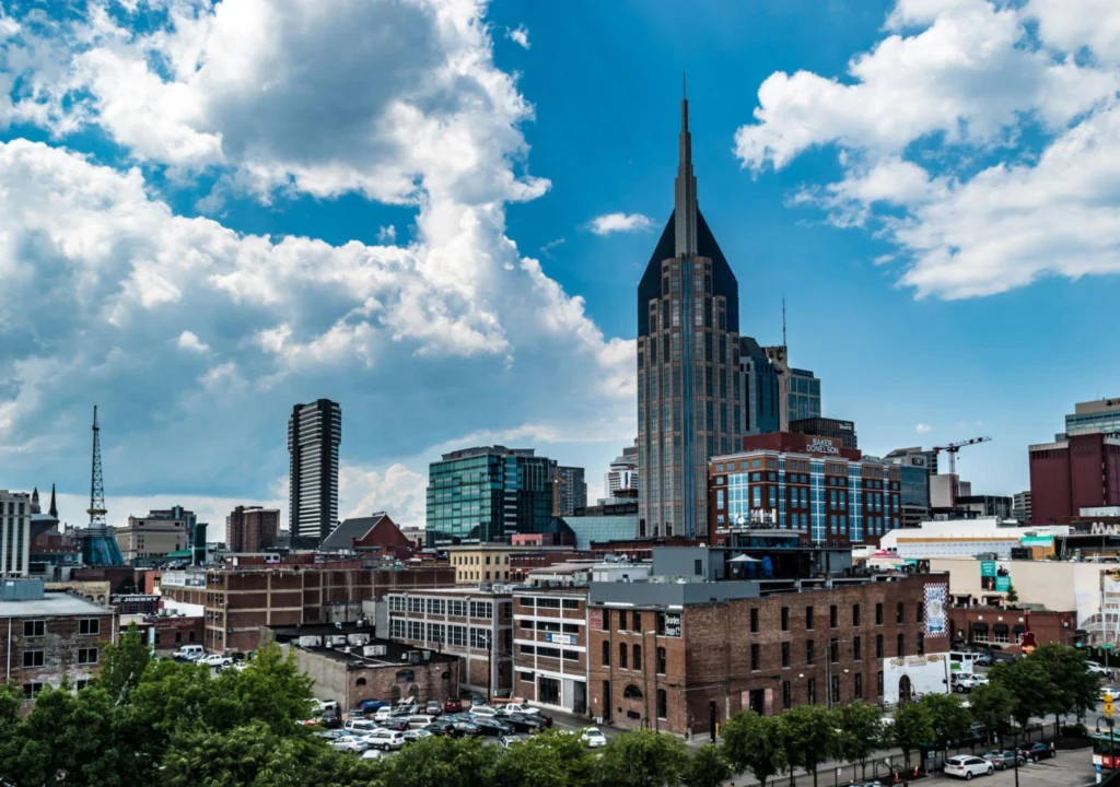 ashville skyline under a blue sky with clouds, representing the city where immigration lawyers serve Tennessee residents.