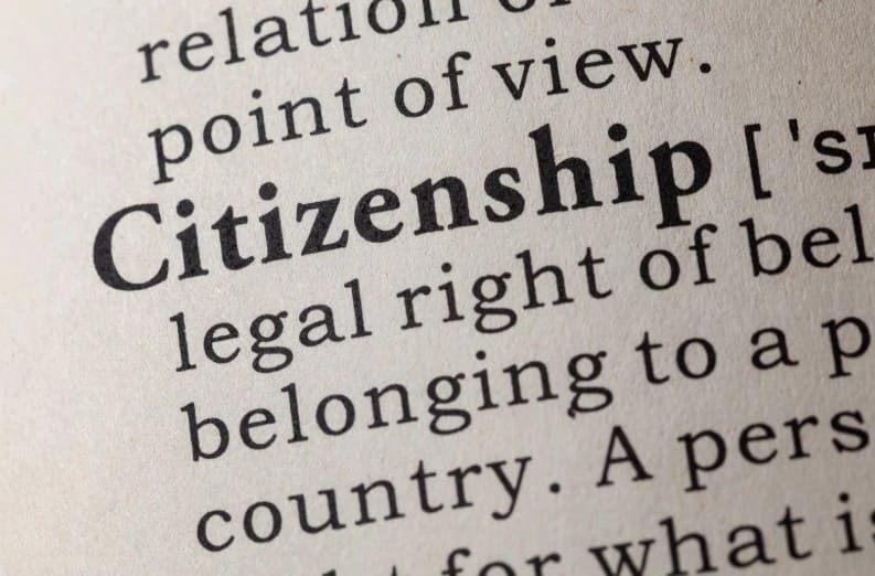 Close-up of citizenship definition in dictionary representing US naturalization and citizenship application process