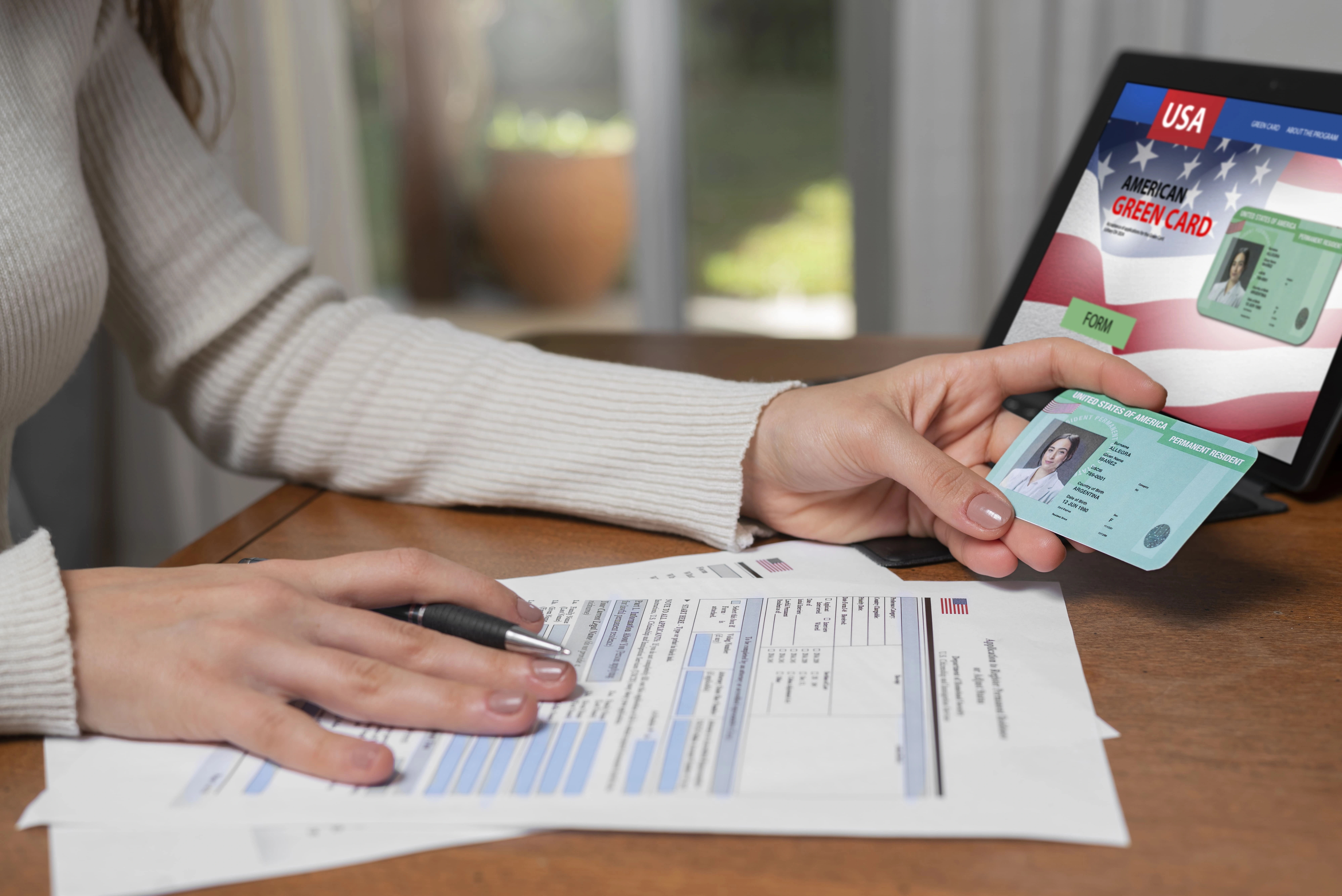 Person reviewing a U.S. green card application while holding a permanent resident card, illustrating the process of applying for a green card from abroad under current immigration rules.