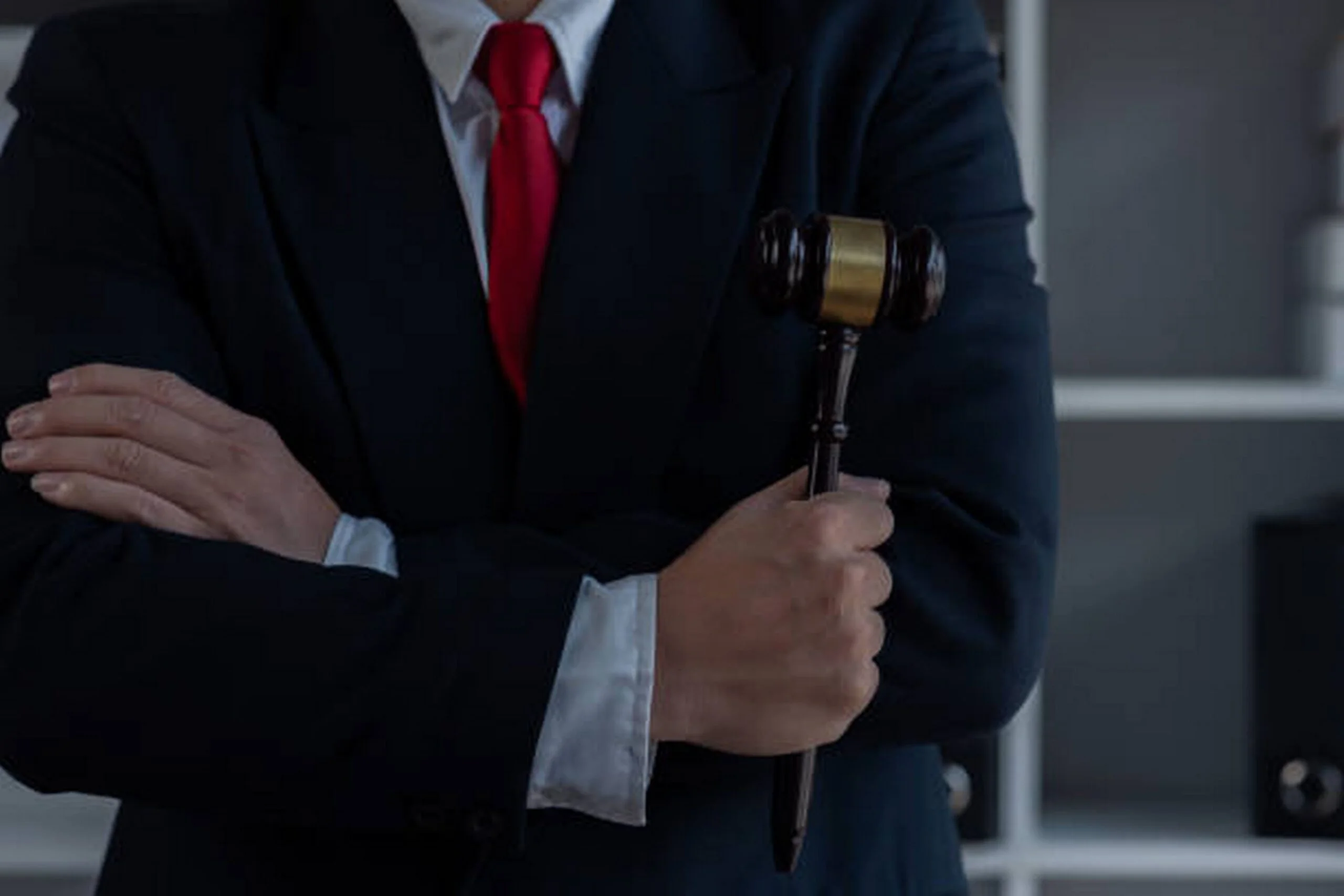 a-deportation-defense-attorney-in-a-suit-and-tie-holds-a-gavel-symbolizing-authority-and-legal-representation-how-a-deportation-defense-attorney-in-los-angeles-and-new-york-can-protect-your-future