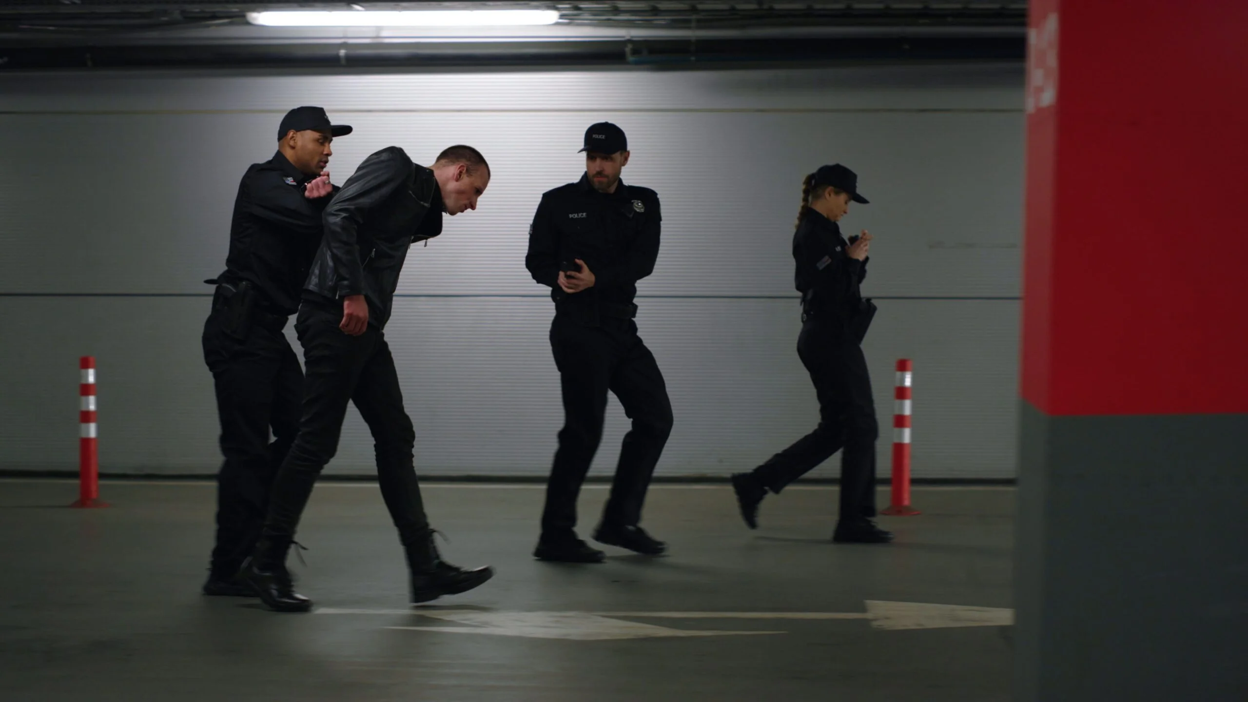 several-men-in-black-uniforms-move-through-a-parking-garage-indicating-a-coordinated-raid-in-progress-ice-immigration-raids-in-los-angeles-what-you-need-to-know-in-2025