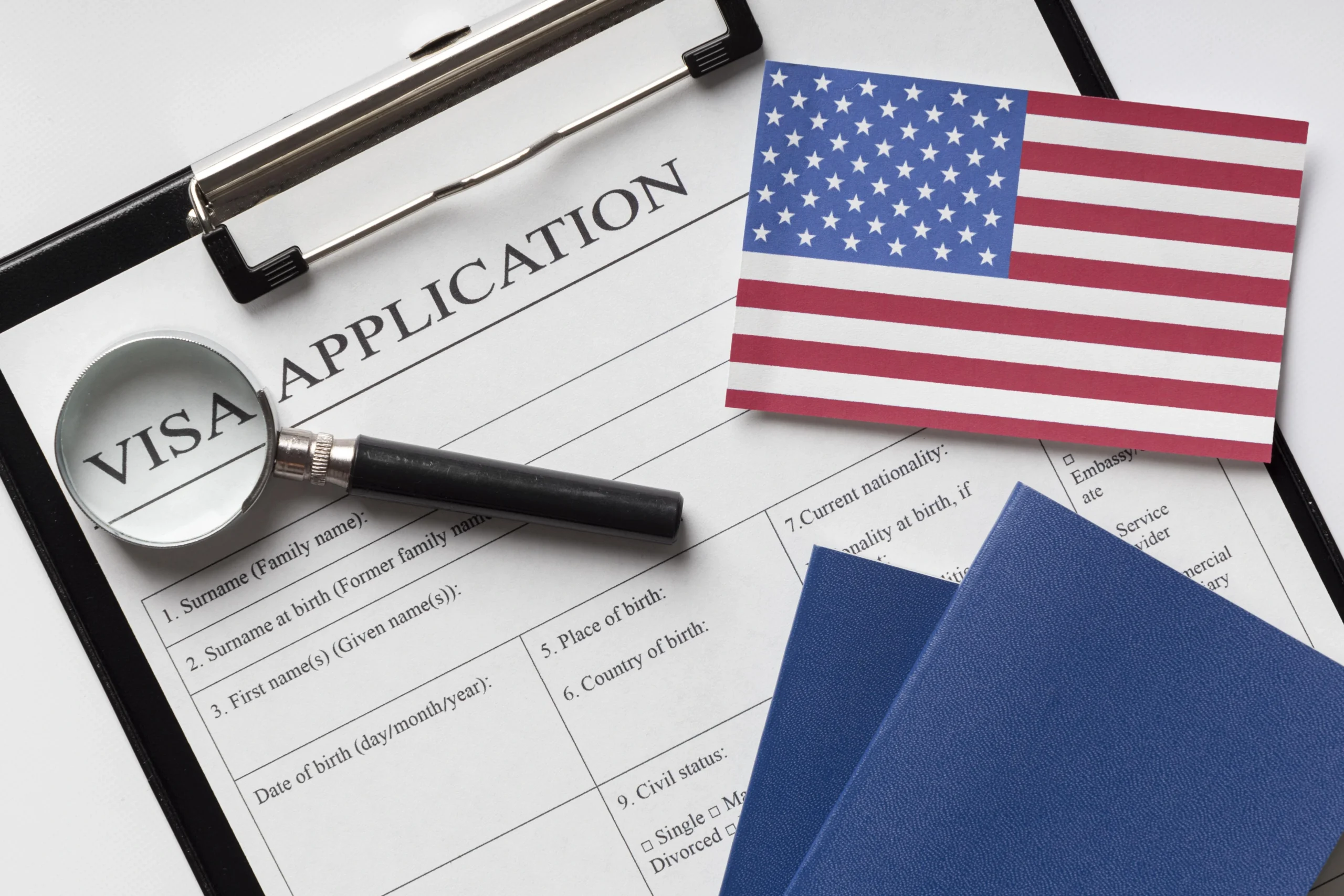 visa-application-form-and-passport-on-a-desk-representing-the-process-for-eb1-green-card-qualification-in-los-angeles