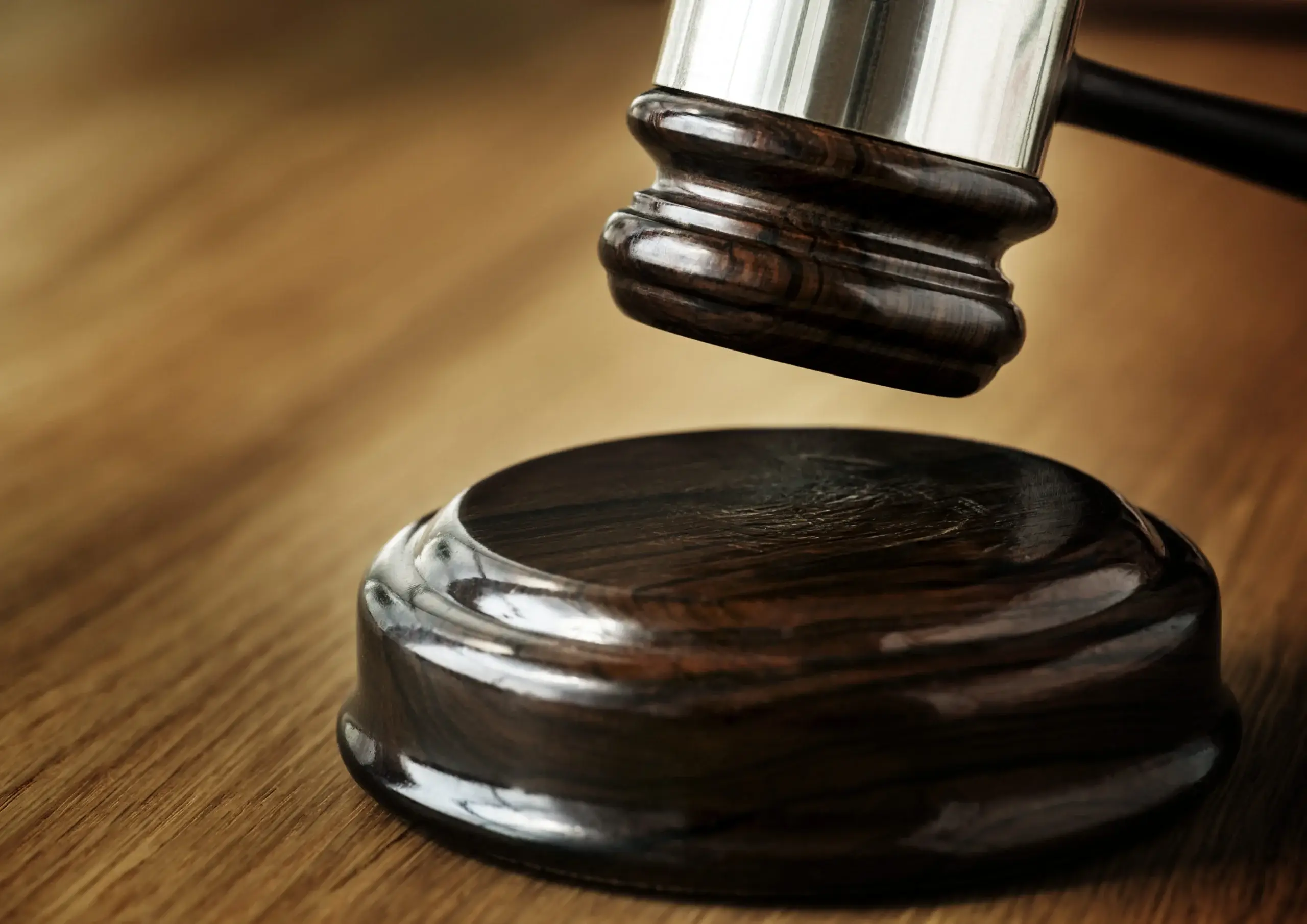 Close-up of a judge’s gavel striking a sound block in a courtroom, representing federal mandamus lawsuits and legal action against USCIS immigration delays.